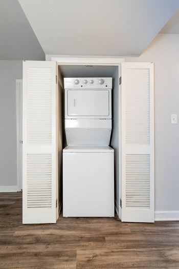 An empty laundry room with a washer and dryer in it